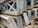 a large pile of metal beams stacked on top of each other