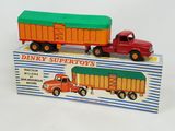two toy trucks that are sitting on top of a box