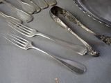 a lot of silverware on a table with silverware on it