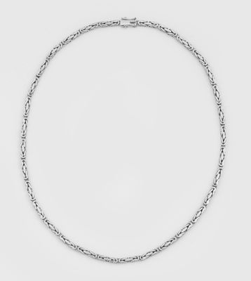 a close up of a silver necklace on a white background