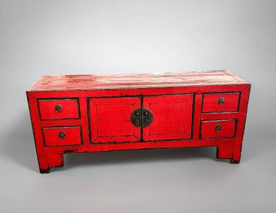 an image of a red table with drawers and drawers on top of it