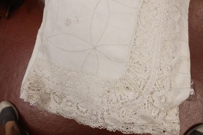 a white pillow on a brown chair with a white pillow on it