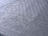 a white table cloth with a floral design on it