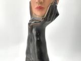a statue of a woman with her hands on her face