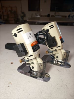 two electric tools that are sitting on a table