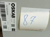 a white refrigerator with a sticker on it in a room