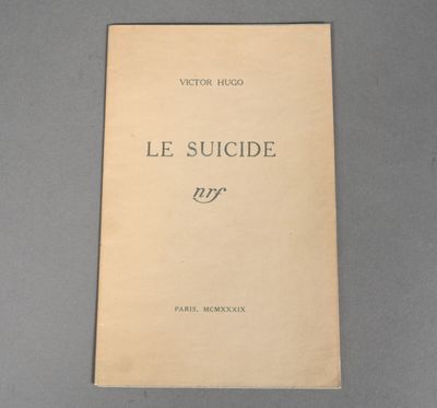 an old book sitting on top of a table next to a black and white photo