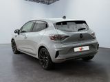 the rear end of a silver car in a white room