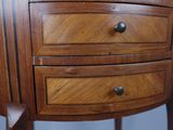 a small wooden table with three drawers on top of it