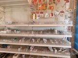 many empty shelves in a store with various items on them