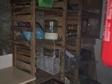 a room with a fire extinguisher, shelves, and a fire extinguisher in the corner