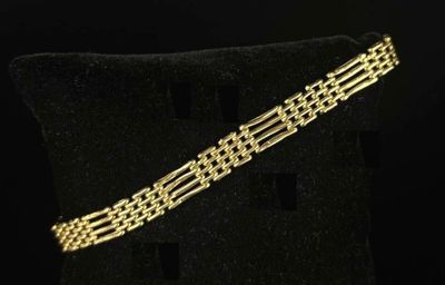 a gold bracelet on a black background