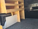 the back of a van with a bed and a television in the back