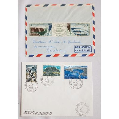 a couple of envelopes with stamps on them sitting next to each other