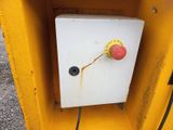 a yellow box with a red button on it