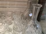 a lot of glass vases and glasses on a table