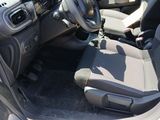 the interior of a car with the door open and the driver ' s seat down