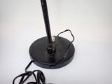 a black lamp that is sitting on a white table