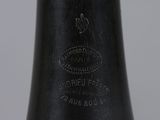 a close up of a black vase on a white table