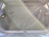 a trunk of a car with the sun shining through it