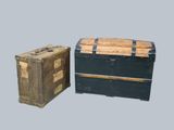 two trunks sitting next to each other on a gray surface