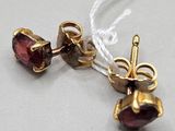 two pairs of garnets are shown on a white string
