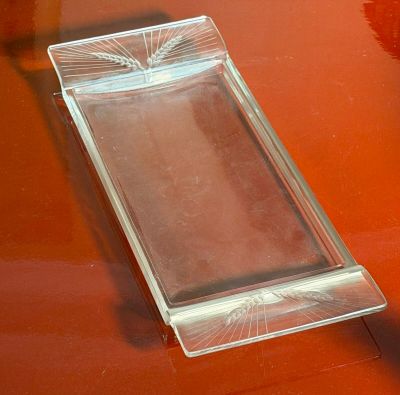 a glass tray on a red table with a cell phone in it