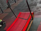 a red bench in the middle of a gym