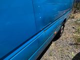 a blue van that is parked on the side of the road