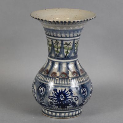 a blue and white vase sitting on a table