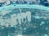 a close up of a bowl of water with bubbles in it