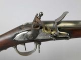 an old gun with a metal handle and a wooden handle