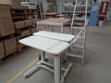 a white table and a white chair in a warehouse