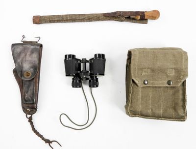 a pair of binoculars and a wooden stick on a white surface