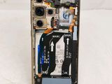 a cell phone with a broken battery attached to the back of it
