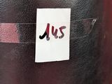 a sticker on the back of a black suitcase