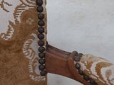 a close up of a chair with beads on it