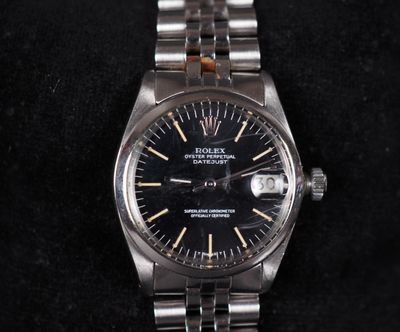 a close up of a watch on a black surface