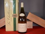 a bottle of wine sitting next to a box of wine