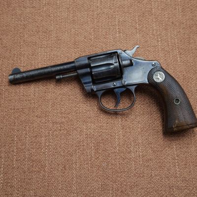 a gun that is on the ground on a brown surface