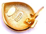 a close up of a gold plated object on a white surface