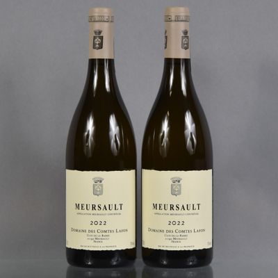 two bottles of wine sitting on top of a table next to each other