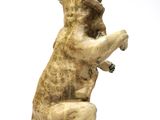 a statue of a bear that is sitting on its hind legs