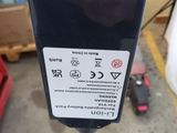 a parking meter with a sticker on it in a parking lot