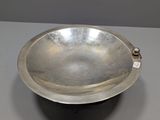 an antique silver plate on a table with a tag on it