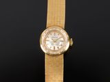 une photo d'une montre-bracelet pour femme avec un bracelet en or