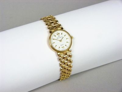 an image of a woman ' s wrist watch on a white napkin