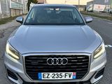 the front view of a silver audi audi car parked on a street