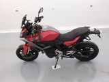 a picture of a red and black motorcycle parked in a room