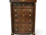 an antique chest of drawers with brass handles and a wooden top
